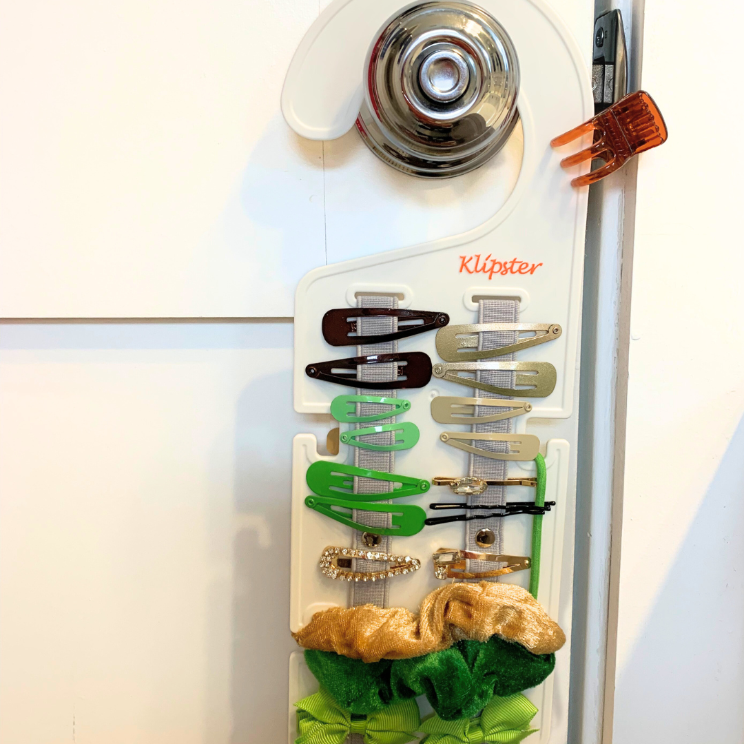 Classic Klipster hair accessories organizer with hanging hook. Compact, double-sided storage for clips, bows, scrunchies, ties, and more. Lightweight and travel-ready.