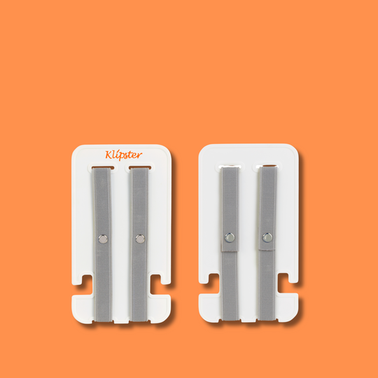 Mini Klipster hair accessories organizer next to an iPhone for size reference. Compact, portable storage for clips, scrunchies, and hair ties.